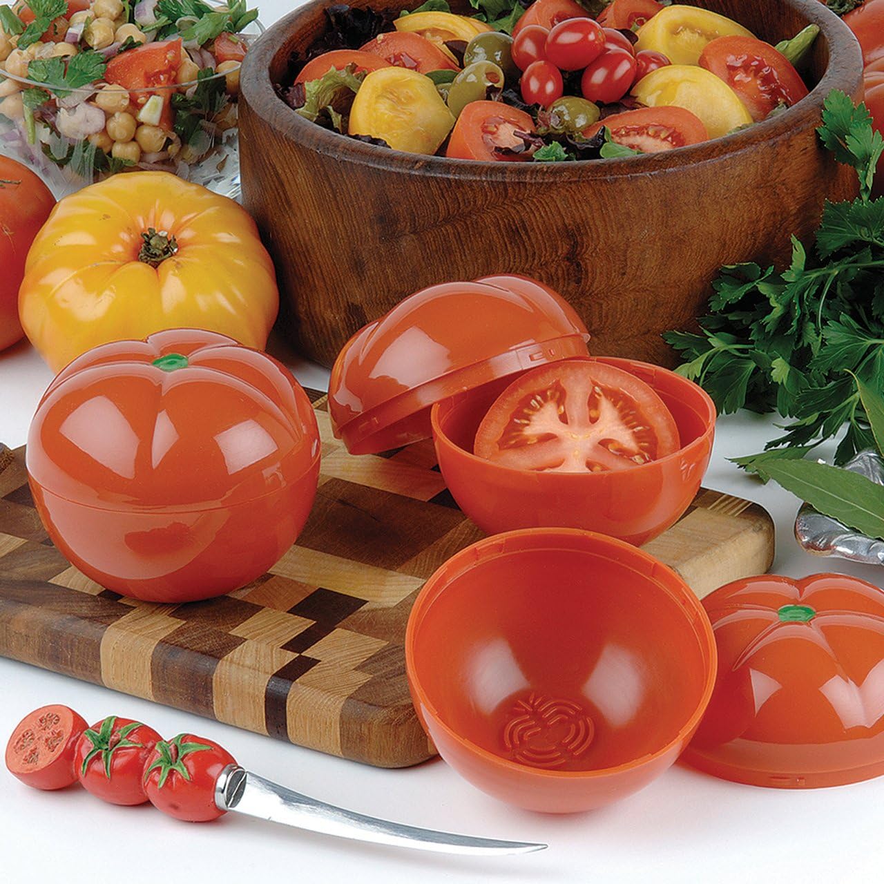 Orange plastic Hutzler Tomato Saver for veggies shown whole and open with a tomato slice inside