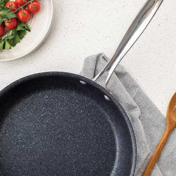 Nordic Ware Basalt 12 saute skillet in dark gray with light speckles and a silver handle on a white counter