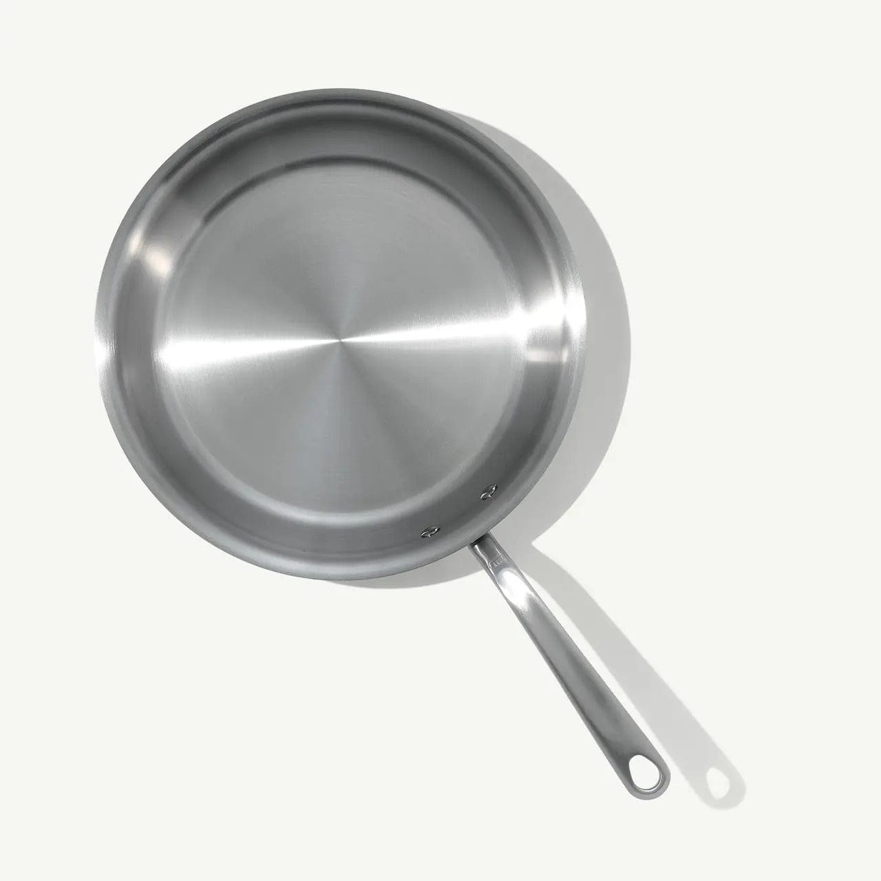 12 stainless clad frying pan with a long handle and hanging hole viewed from above