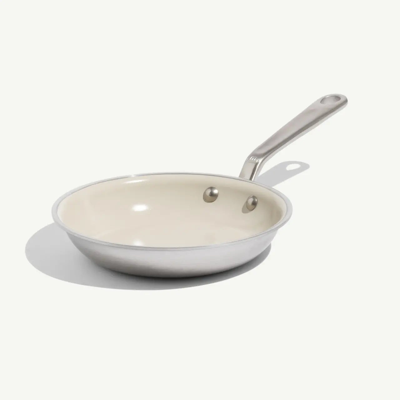 8 CeramiClad frying pan with a cream-colored non-stick interior and a brushed stainless steel exterior and handle