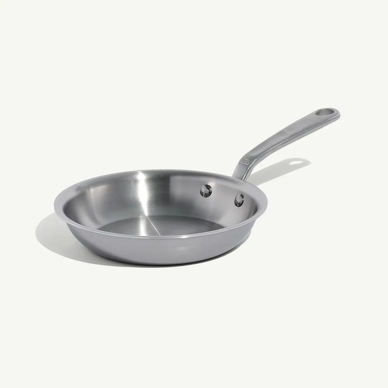 8 Stainless Clad Frying Pan with a brushed metal finish and long handle angled from the side