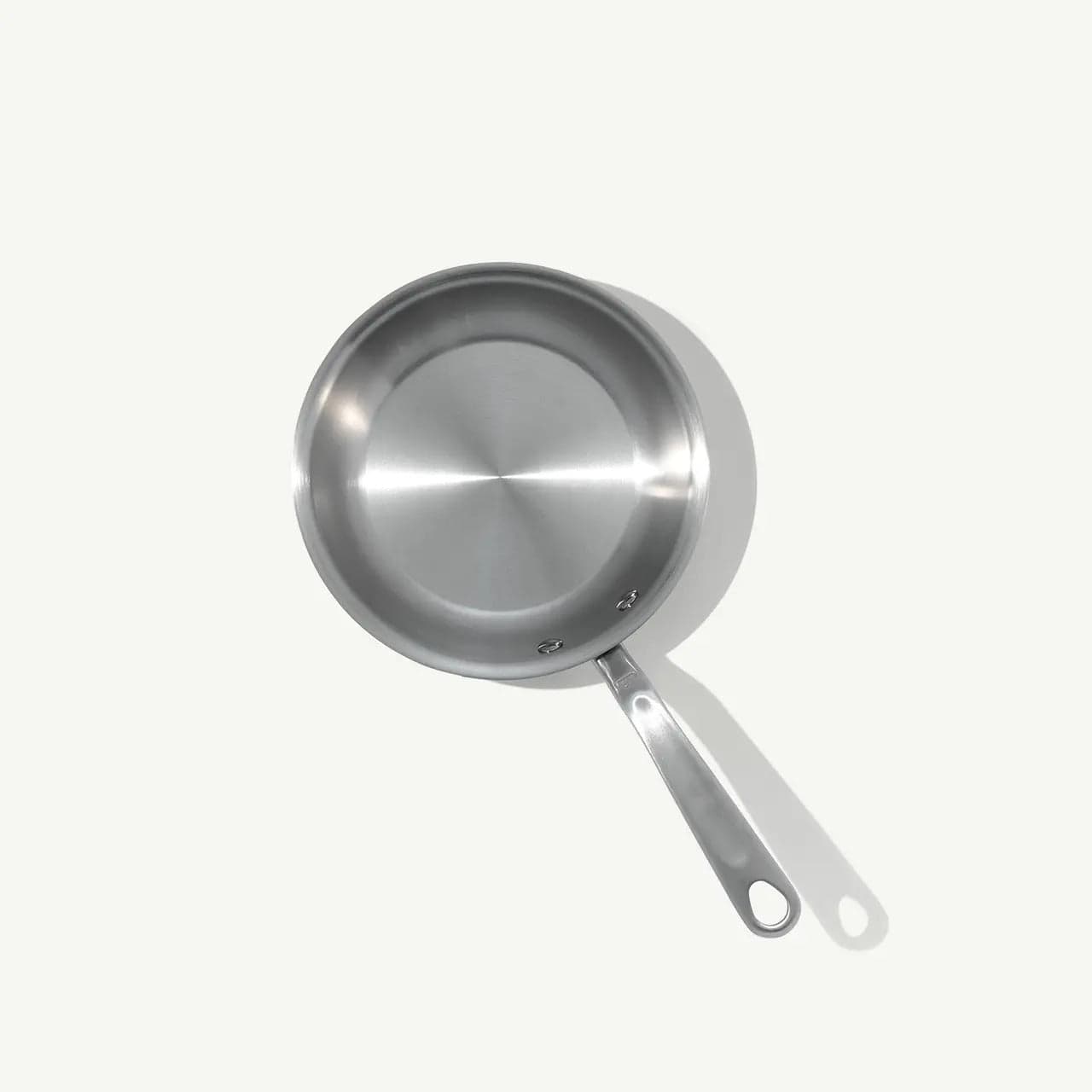8 stainless steel clad frying pan with brushed finish angled view on a white background with subtle shadow