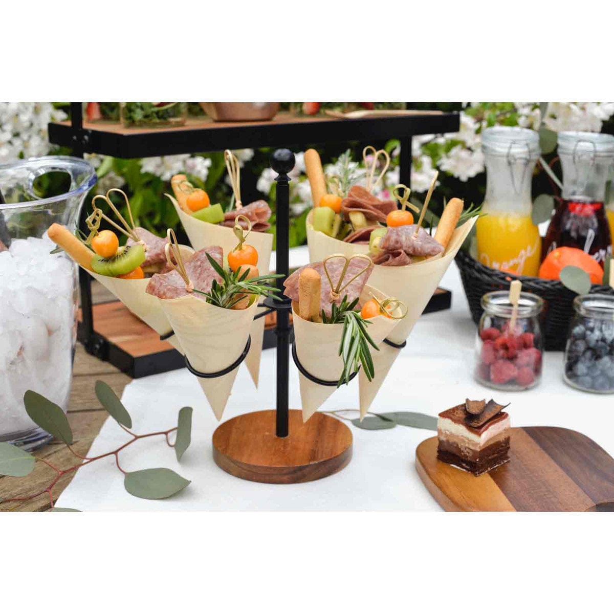 4 5 natural bamboo picks with a decorative knot used for appetizers in cones on a display stand