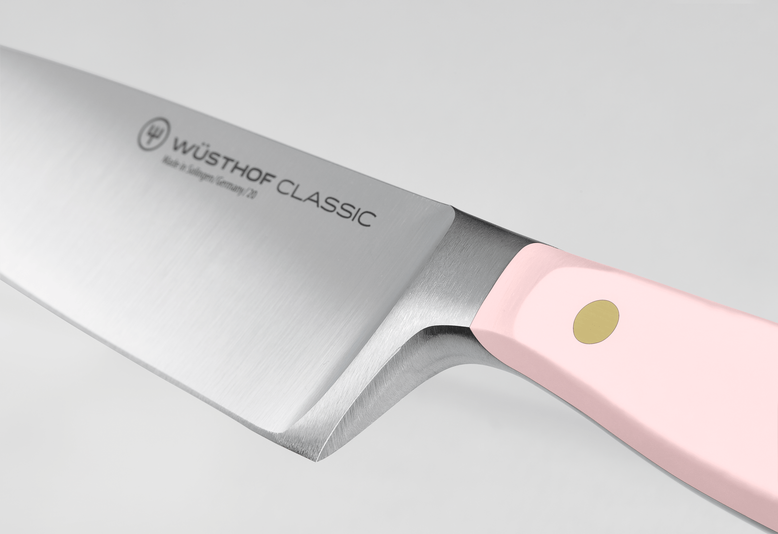 Wusthof Classic 8 Chefs Knife with a silver blade and a light pink handle featuring a single gold rivet