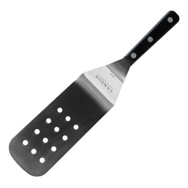 Lamson stainless steel slotted turner with a black riveted handle angled against a white background