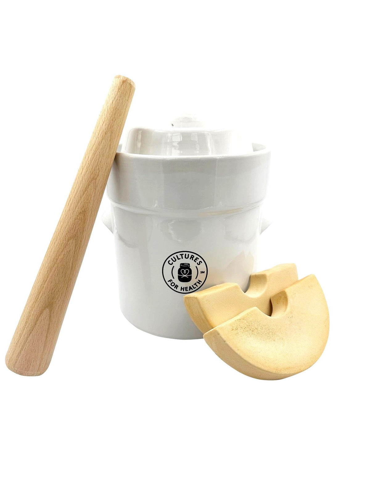 White ceramic fermentation crock with lid wooden tamper and two crescent-shaped fermentation weights