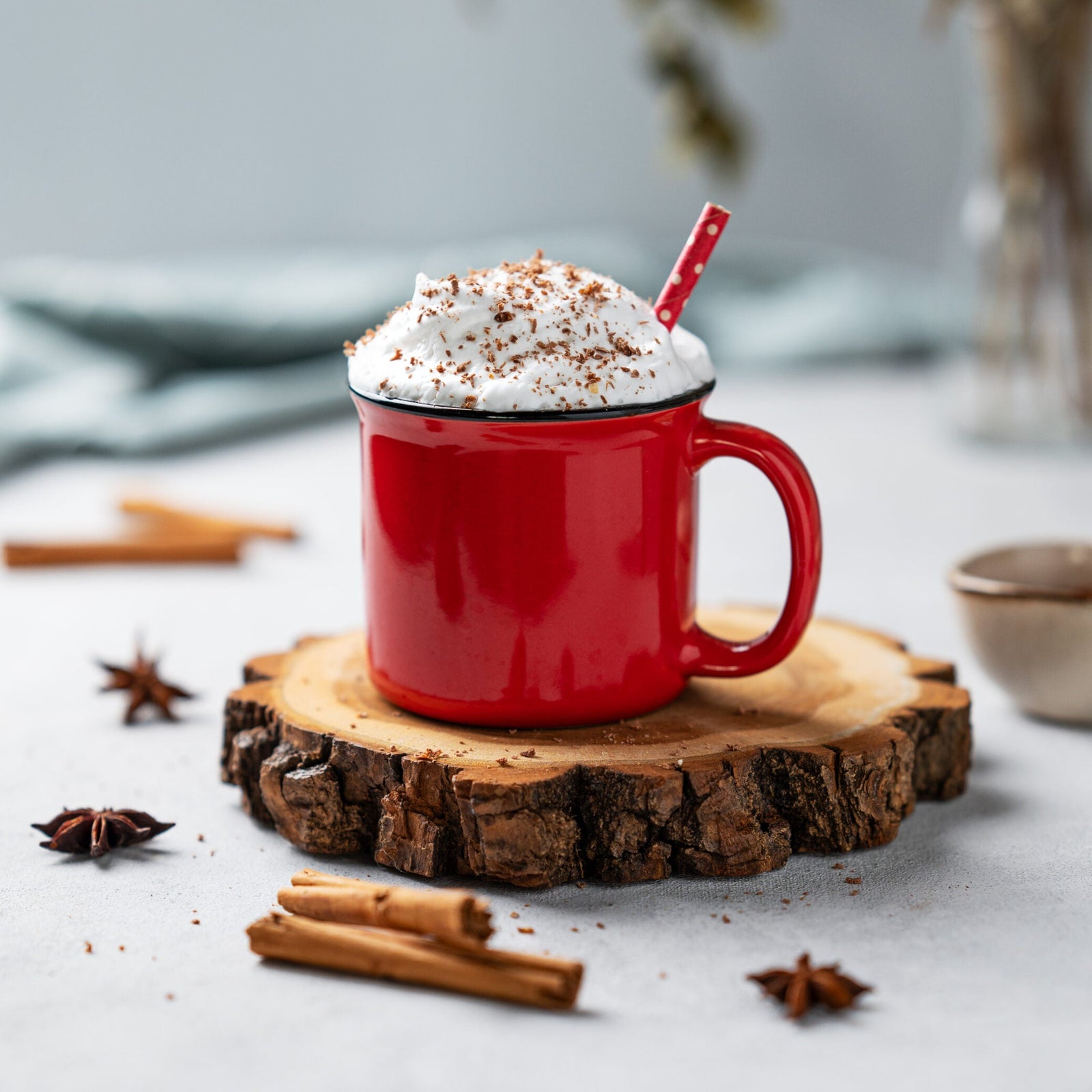 P44 FestiveRedMug ceramic mug in red filled with whipped cream cocoa powder and a red-and-white straw