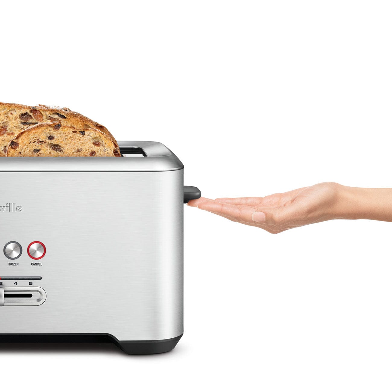 Breville stainless steel toaster with two slices of toast a users hand next to the black toast button