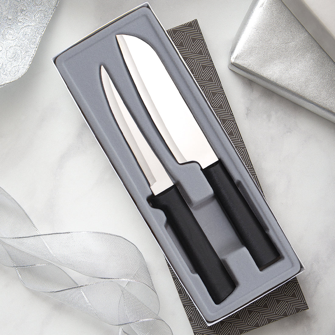 2-piece stainless steel knife set with black handles in a grey foam-lined gift box with geometric pattern trim
