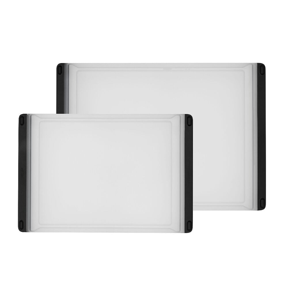 Two white cutting boards with black sides one large and one small stacked on a white background