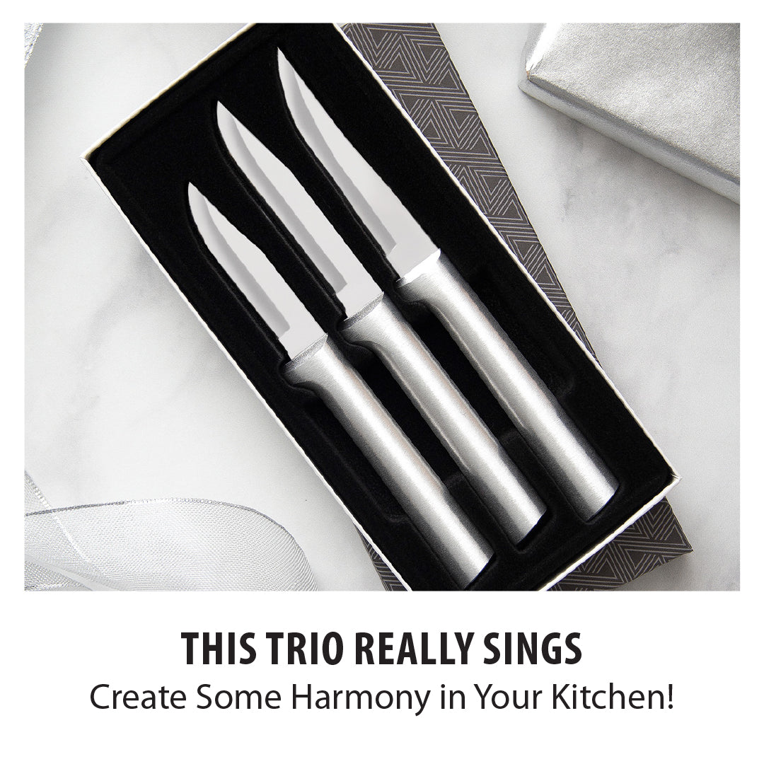 Three stainless steel paring knives with silver handles in a black gift box with geometric pattern