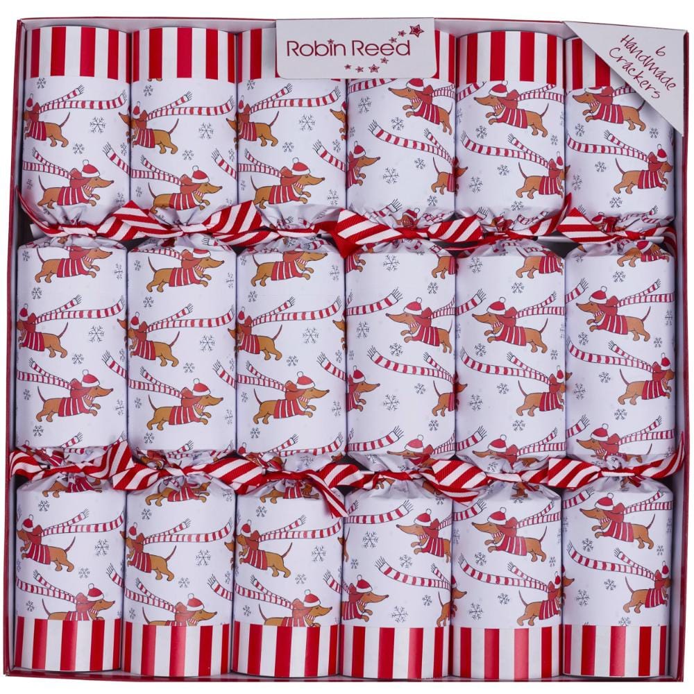 Six Christmas crackers with white red striped and sausage dog designs in a box